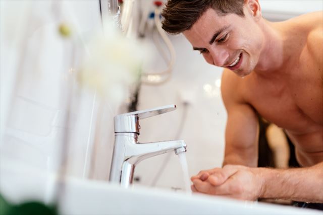 洗顔前に手を洗う男性の画像
